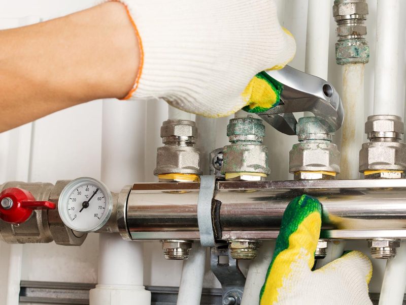 Worker hands fixing heating system